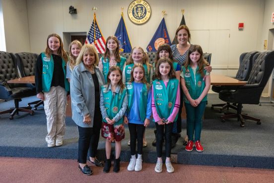 Supervisor Carpenter stands with girl scouts for group photo