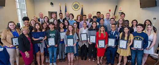 Students stand with their certificates and Town Board