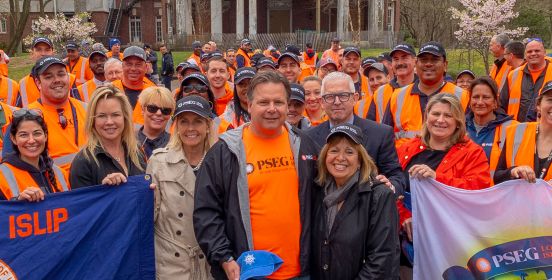Supervisor Carpenter, Councilwomen Mullen and Bergin along with DPW and Parks Commissioner Owens pose with PSEG Staff and Volunteers on the beautiful grounds of Brookwood Hall holding Town of Islip and Earth Day 2019 flags