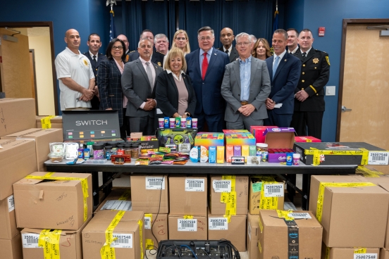 County, Town, Law Enforcement, and Local Officials in group photo before some of the seized materials.