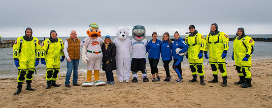 Supervisor Carpenter poses with Quacker Jack, Scuba Divers, cheerleaders and mascots at the Polar Plunge event