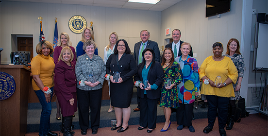 Supervisor Carpenter and the Islip Town Board pose for a photo in the Town Board Room with the Women of honor