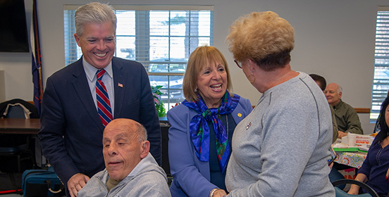 Supervisor Carpenter speaks with one of the members of the Central Islip Senior Center 