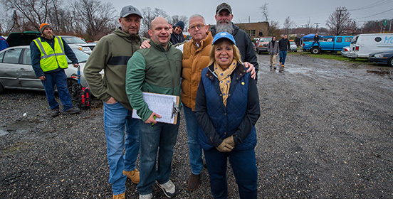 Supervisor Carpenter joins DPW Commissioner Tom Owens and members of the public works department in front of the cars to be auctioned off