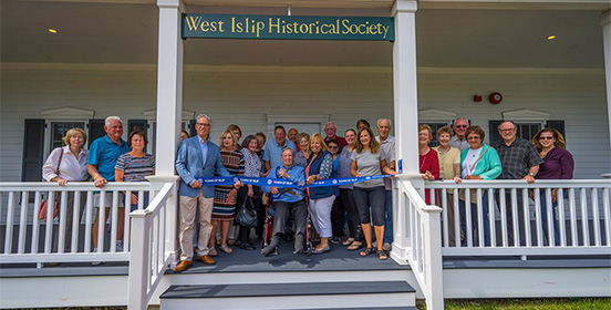 Supervisor Carpenter joins members of the West Islip Historical Society for the ribbon cutting of their new home