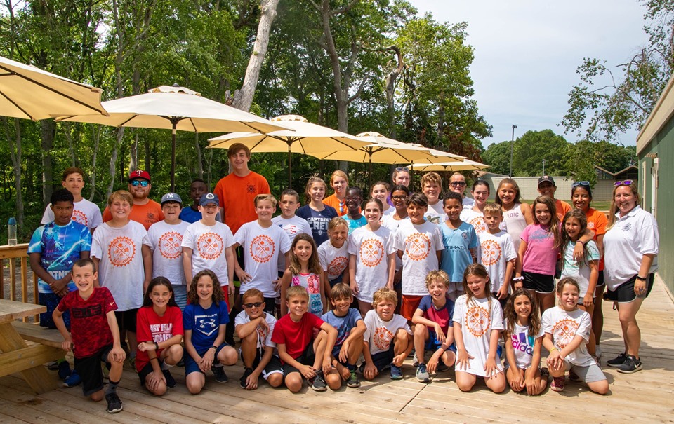 Campers of Camp Byron on the Lake pose for a photo at the new camp trailer.