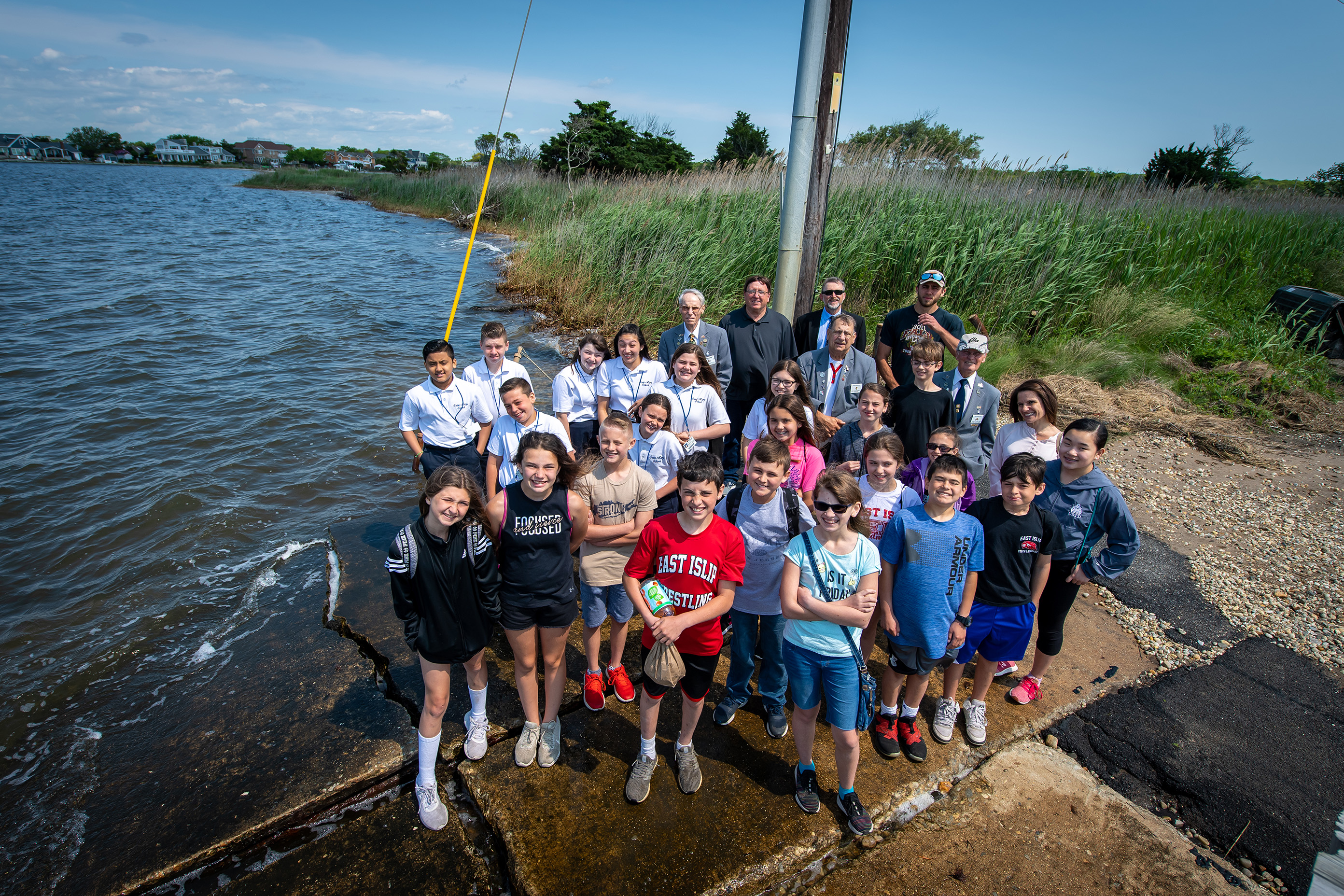 Students attending the Youth in Government Day stand near the Bay at the Town's Shellfish Hatchery.