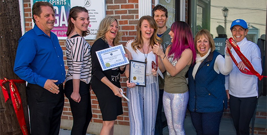 Supervisor Carpenter and Councilwoman Mary Kate Mullen pose with the Sayville Chamber of Commerce and the owners of Free Spirit Yoga outside the new business