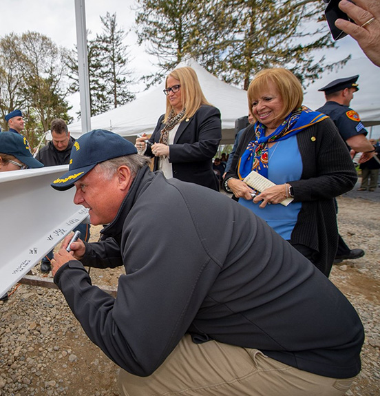 Councilman John Cochrane signs beam for the new Lt. Michael P. Murphy Museum