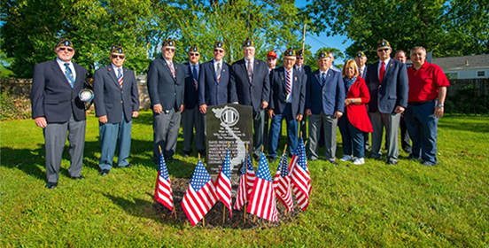 Supervisor Carpenter stands with Veterans at a memorial Day Celebration 