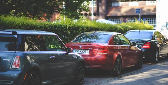 Three cars parked on the street.