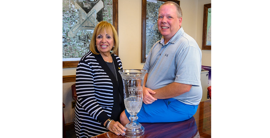 Town Supervisor Angie Carpenter and William Welch pose side by side with trophee.