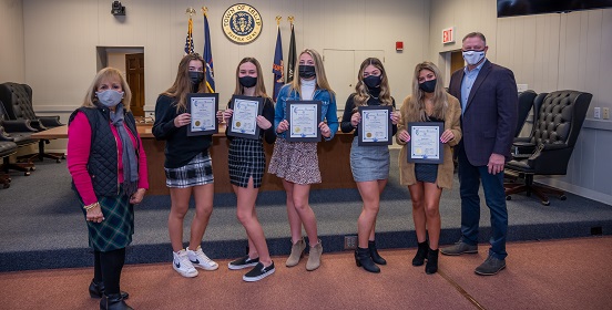 Five students hold certificates of honor given to them by Supervisor Carpenter. The girls of Sayville High School were honored for creating food pantries within their community to help those suffering with food insecurities 