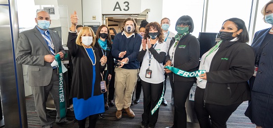 Supervisor Carpenter and staff of Frontier cut the ribbon for their new service to Fort Lauderdale