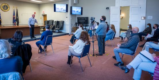 socially distanced masked employees at training session