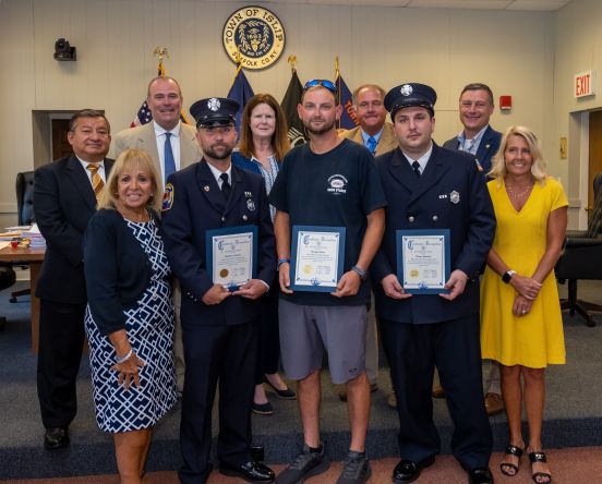 Supervisor Carpenter and the Islip Town Board stand with Firefighters Michael Hand, Matthew Arthurs and Danny Blasucci who were honored for their heroic actions rescuing a woman and her three dogs. 