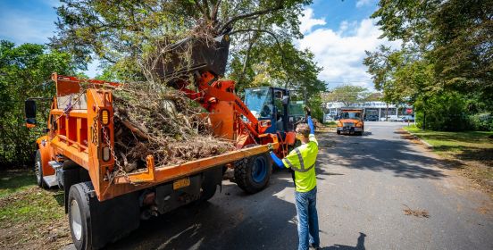 town vehicle collecting storm debris