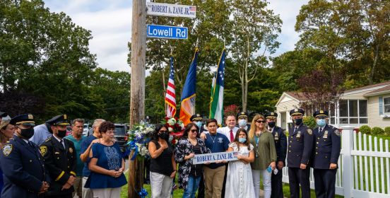 the family of Robert Zane Jr. poses with new street sign