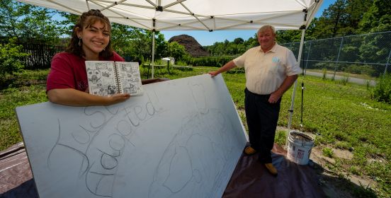 artist and dec commissioner posing near started work