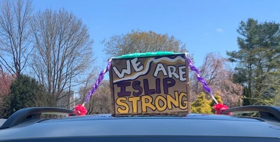 Sign ontop of car says we are islip strong