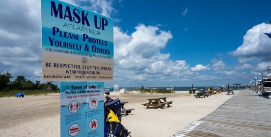 Boardwalk at Atlantique with a sign reminding beach goers to 'mask up'