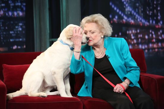 Betty White hugging a dog