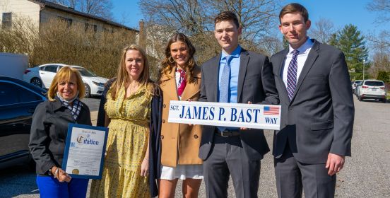 Sueprvisor Carpenter with Family presenting citation and street sign