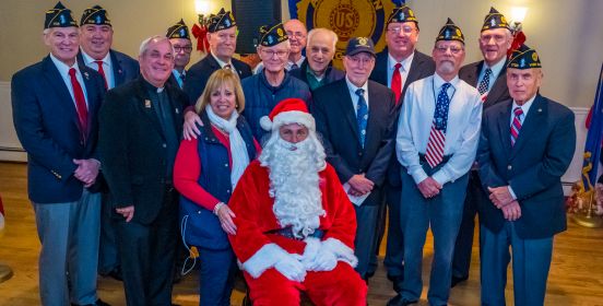 Town Supervisor Angie Carpenter poses for a photo with American Legion members and Santa in the center.
