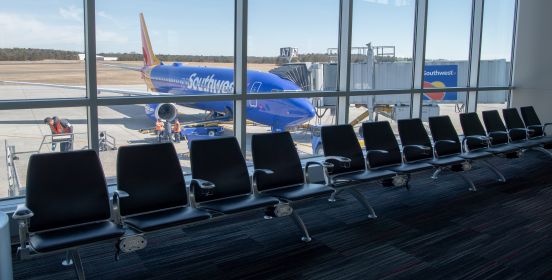 seats inside terminal looking out windows to southwest airlines