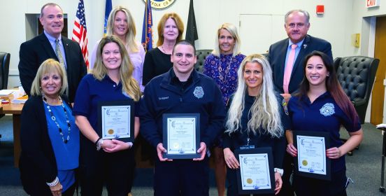 Islip Supervisor Angie Carpenter and the Islip Town Board pose for a photo with the Sayville EMTs.