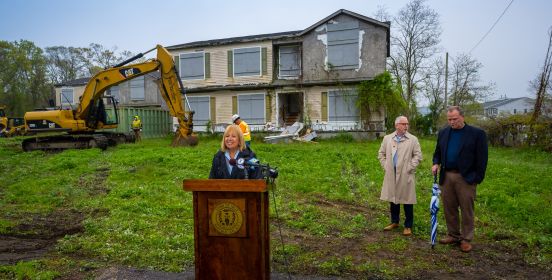 Supervisor Carpenter at podium in front of demo house