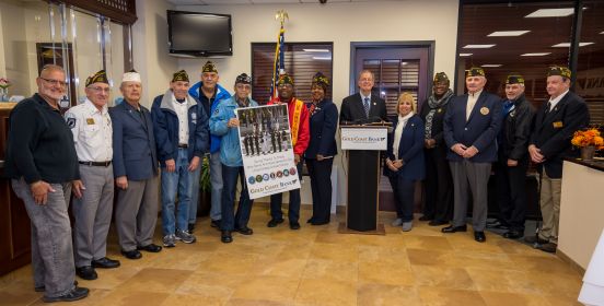 Town Supervisor Angie Carpenter poses for a photo with the Veterans who were honored as well as Gold Coast Bank staff.