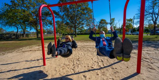 Supervisor Carpenter and Assemblyman Ramos swing on swingset