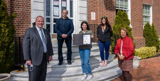 Supervisor and Councilman on Town Hall steps honoring teen