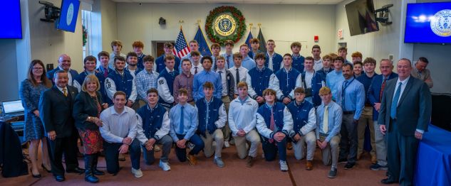 wide shot of bayport bluepoint football team with elected officials