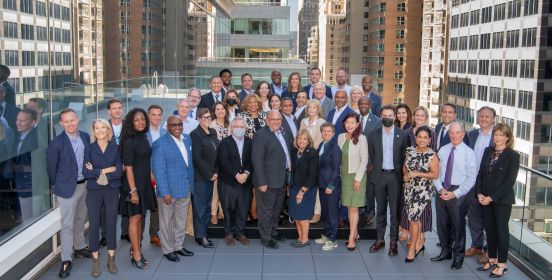 Supervisor Carpenter alongside 37 mayors and government leaders in group photo on terrace with city in background