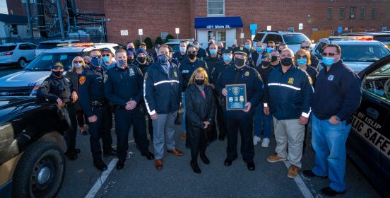 Group shot of Supervisor, Sgt. Public Safety Officials in front of 401 Main St.