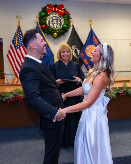 Couple smiles as Supervisor officiates wedding