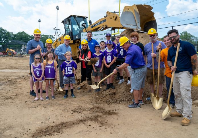 Officials and teams ground breaking shovels
