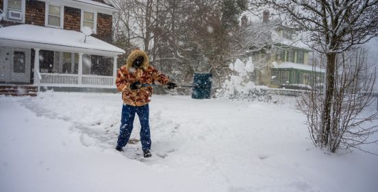 man shovels yard