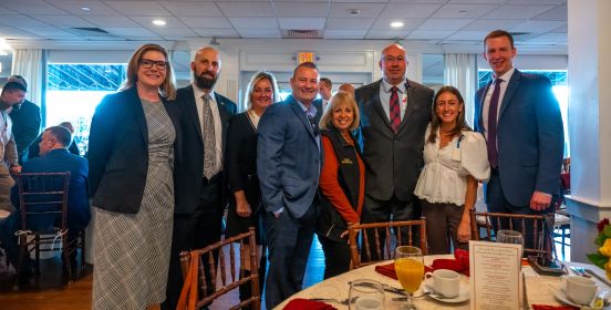 Supervisor Carpenter in group photo at Food For Hope Breakfast 2023