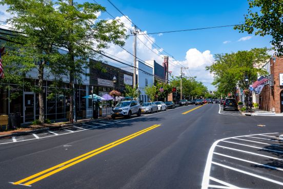 A photo of downtown Bay Shore under sunny skies and green trees