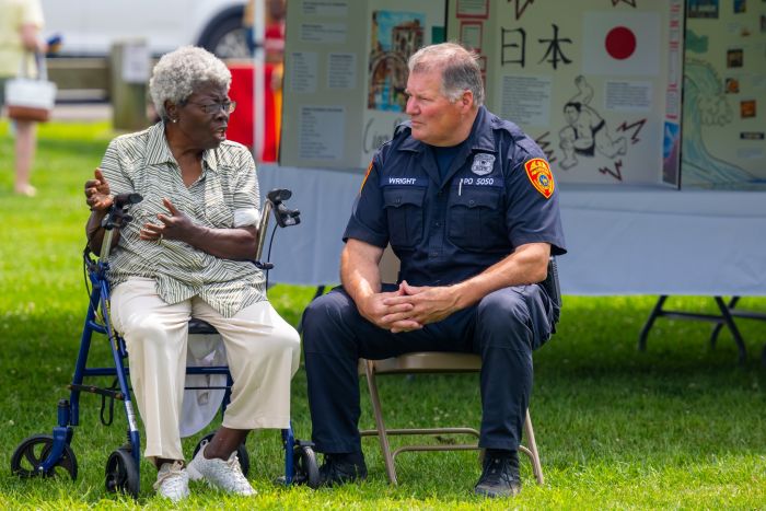 Uniform SCPD officer sits down to speak with elder