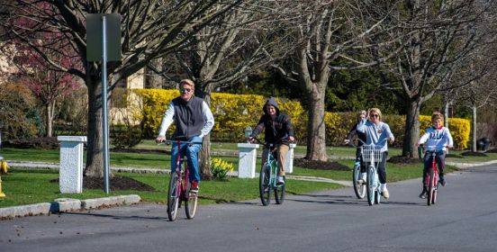 family on bikes on a sunny day keep healthy distance