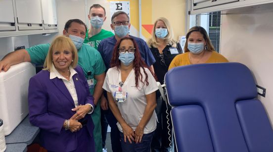 Supervisor Carpenter, Personnel and Northwell Health Staff in group photo within wellness truck