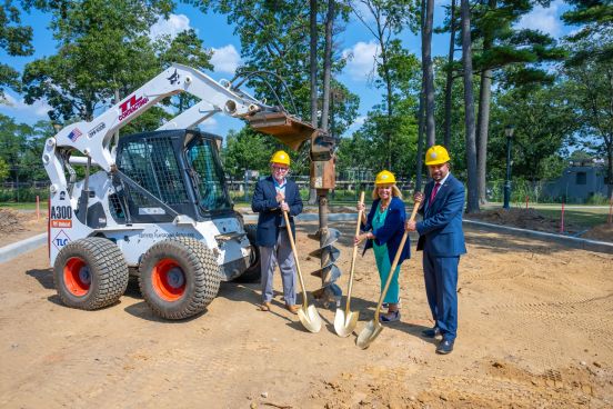 DPW Commissioner Owens, Supervisor Carpenter, Assemblyman Ramos pose with shovels in dirt, heard hats, and bobcast digging tool