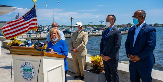 waters of the great south bay flow in the daylight while the press conference is underway