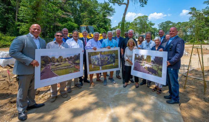 Officials hold up renderings of park