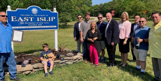 group photo at sign