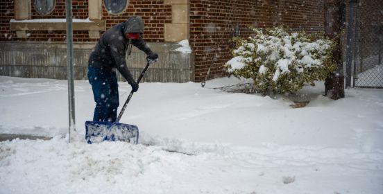 man shovels yard